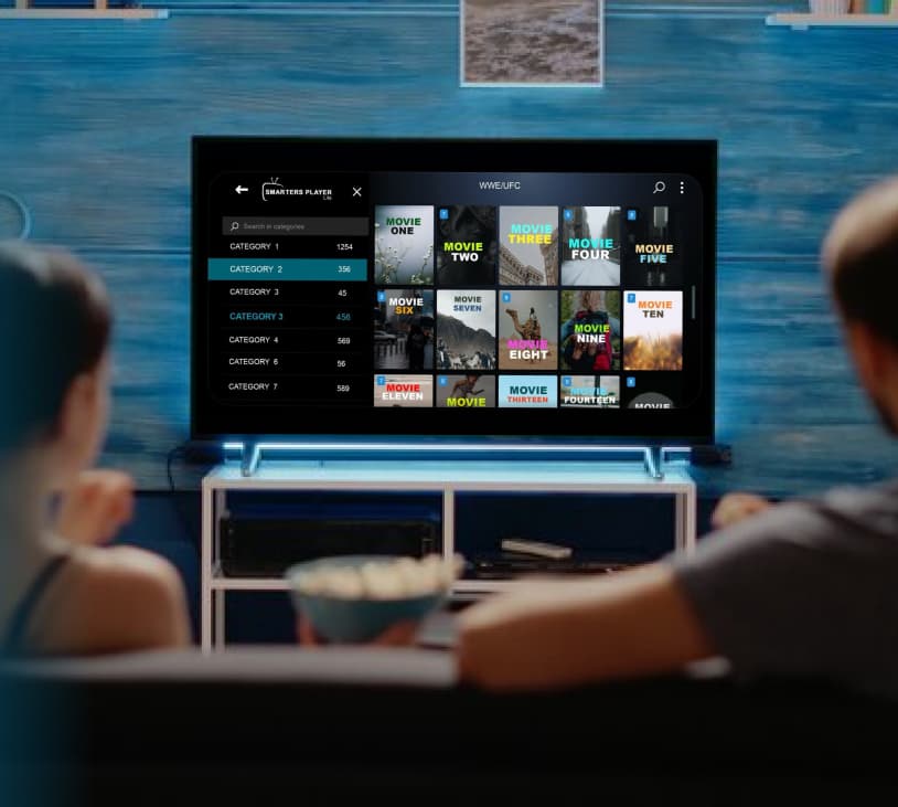 Two viewers watching live TV through an IPTV player app on a home media setup